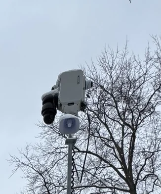Camera and speaker assembly on a mobile surveillance tower